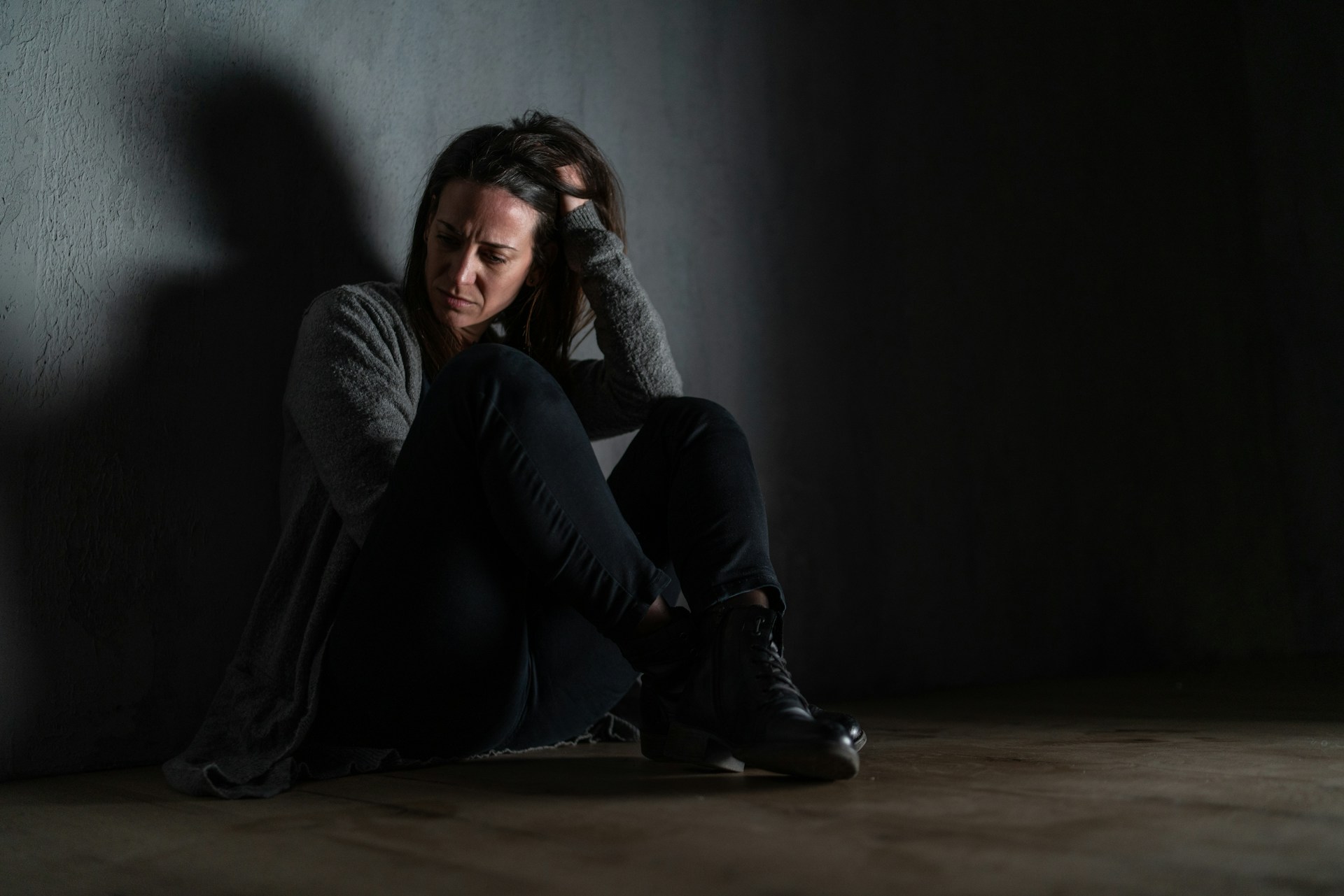Woman sitting quietly while her partner offers support during a difficult evening