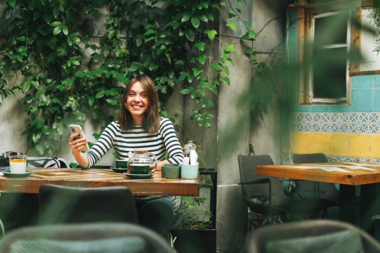 single woman enjoying a coffee while embracing her single life after a relationship